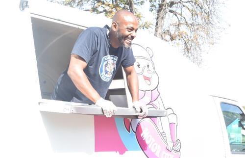 Motor City Sweet Treats Ice Cream truck owner serving ice cream